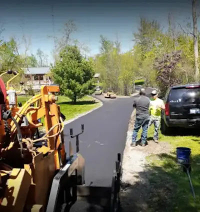 Paver and crew working a residential drive