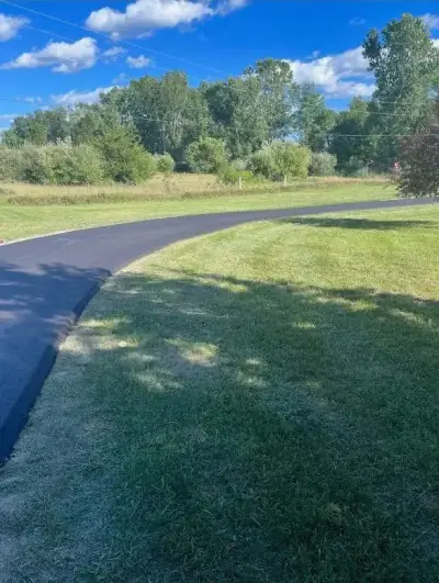Curved drive across a landscaped lawn