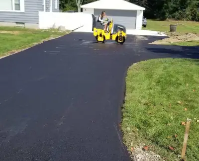 Roller compacting a new driveway