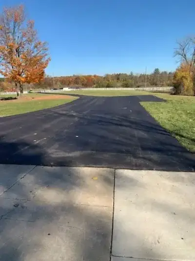 New asphalt meeting an existing concrete pad